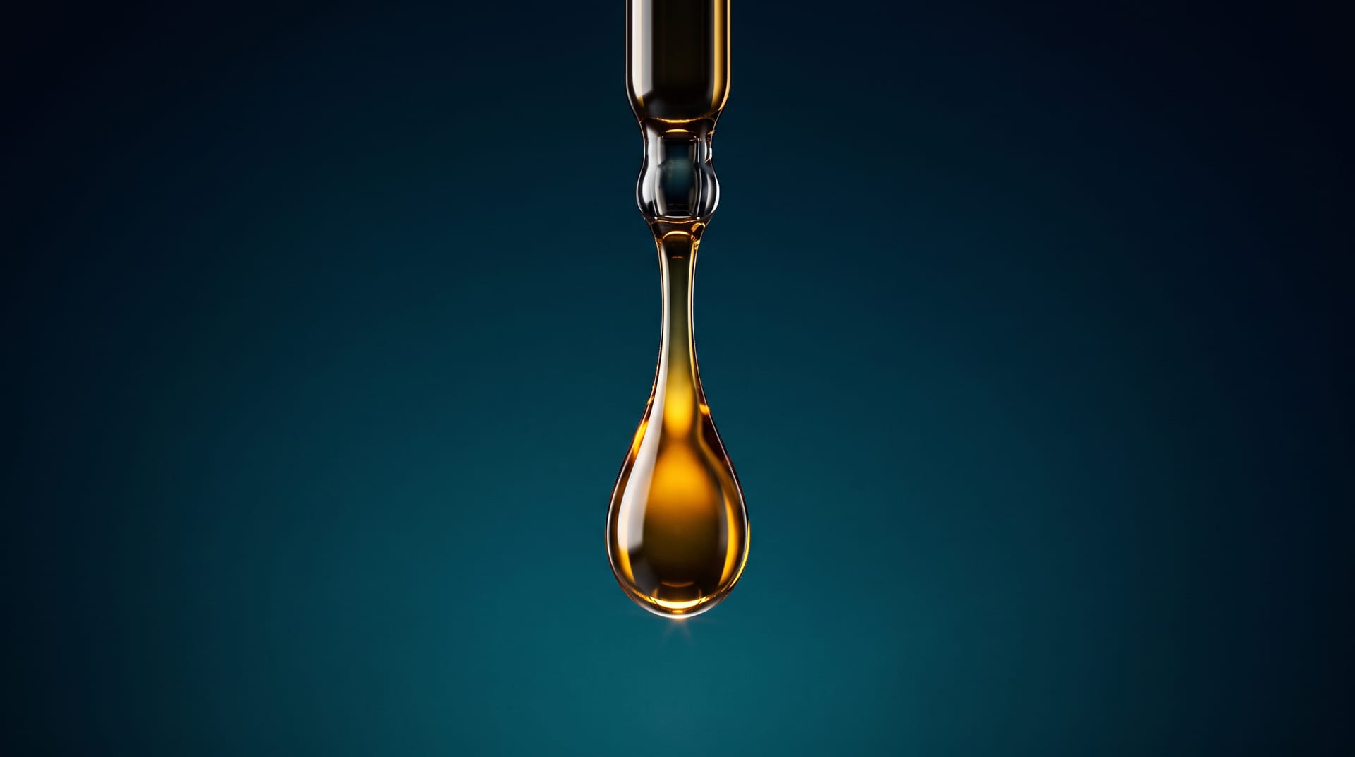 Macro studio photograph of a glossy amber diesel fuel droplet